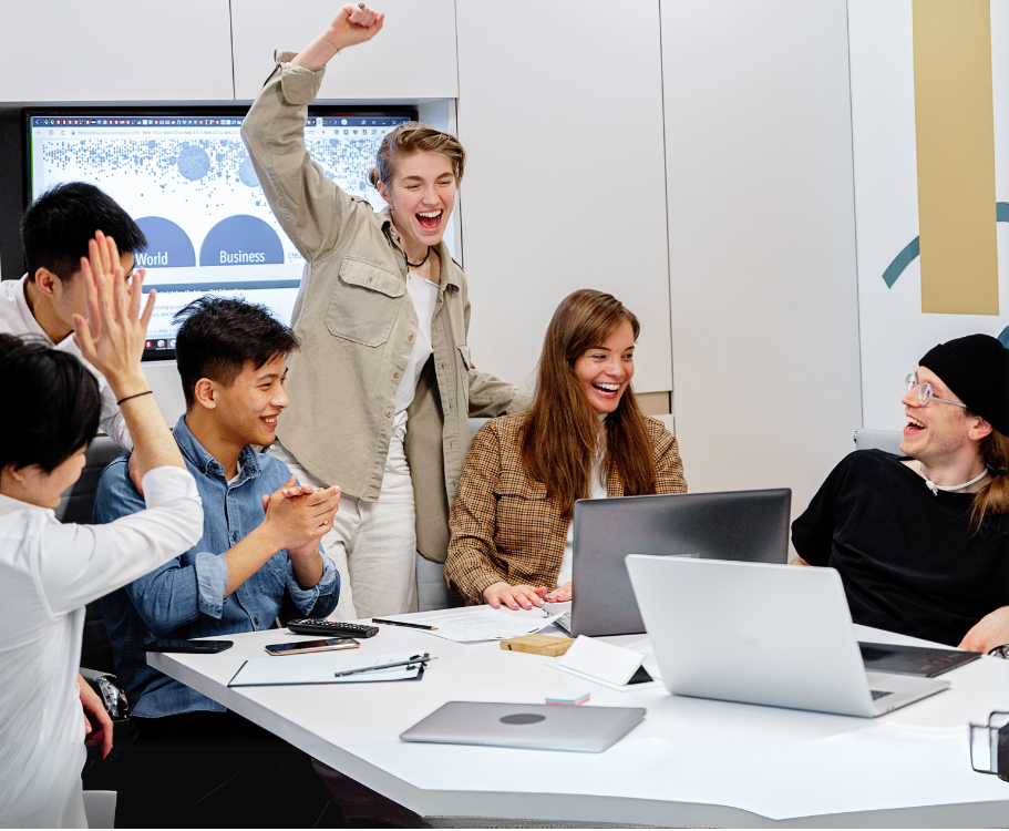 Colleagues celebrating a success together at a table.